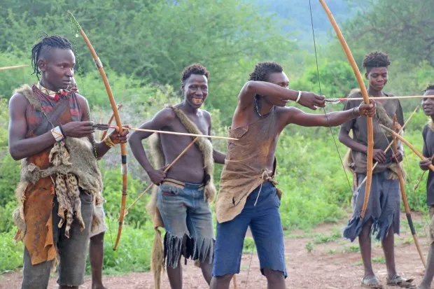 The Hadza bushmen, shown here at target practice, survive by expertly hunting animals like their ancient forebears. (Photo by Norma Meyer)