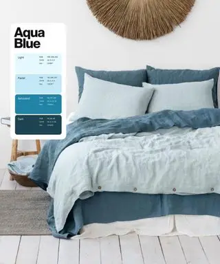 An aqua blue-themed bedroom with shades of light and darker teal bedding and rattan accents