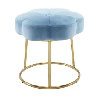 An aqua blue velvet stool shaped like a flower, with a circular gold metal hardware base