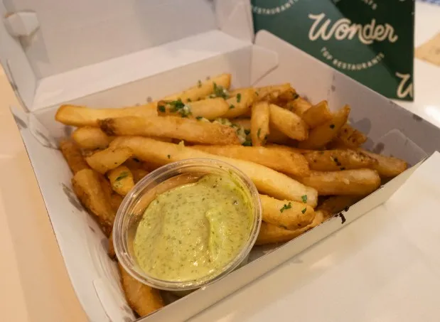 Garlic fries from Fred's Meats & Bread are among the items available at the new Wonder food hall inside the Walmart at Richland Crossings shopping center in Richland Township. Wonder offers food from eight different restaurants including Tejas Barbeque, Fred's Meats & Bread and Alanza Pizza. (April Gamiz/The Morning Call)