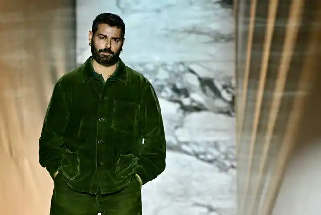 Designer Fausto Puglisi greets the audience at the end of the Roberto Cavalli fashion show at Milan Fashion Week on Feb. 21, 2024.