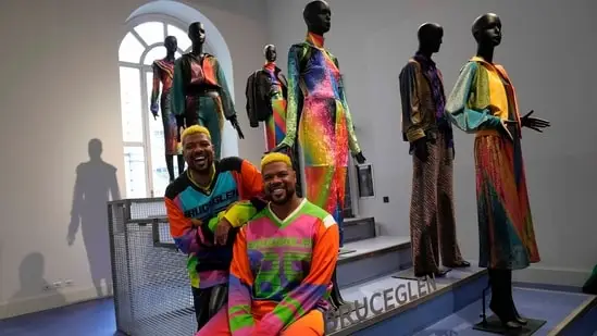 From left, designers Glen and Bruce Proctor pose for portraits in front of their creations at the fashion hub part of the women's Fall-Winter 2024-25 collection presented in Milan, northern Italy.(AP Photo/Antonio Calanni)