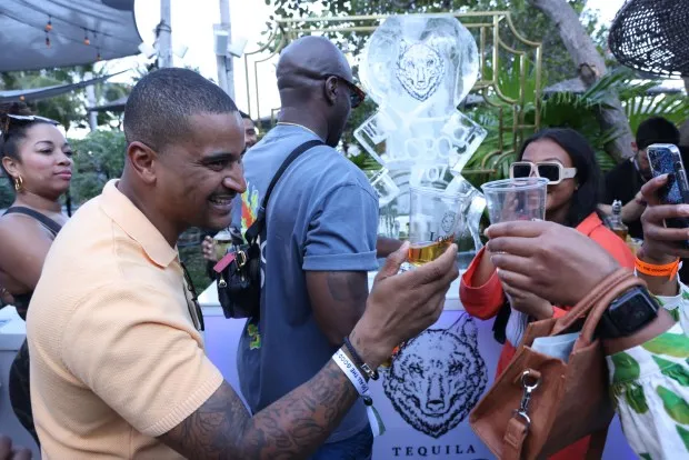 Chef JJ Johnson, left, toasts guests at the inaugural The Cookout event at the 2023 South Beach Wine and Food Festival. The Cookout returns this week poolside at the Eden Roc Miami Beach hotel. (South Beach Wine and Food Festival / Courtesy)