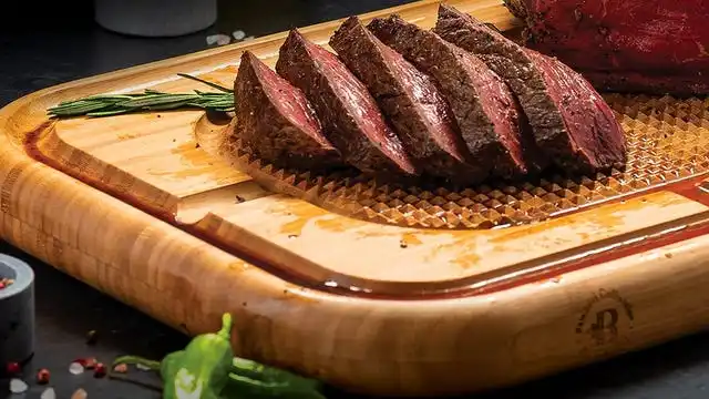 cutting board with meat on top