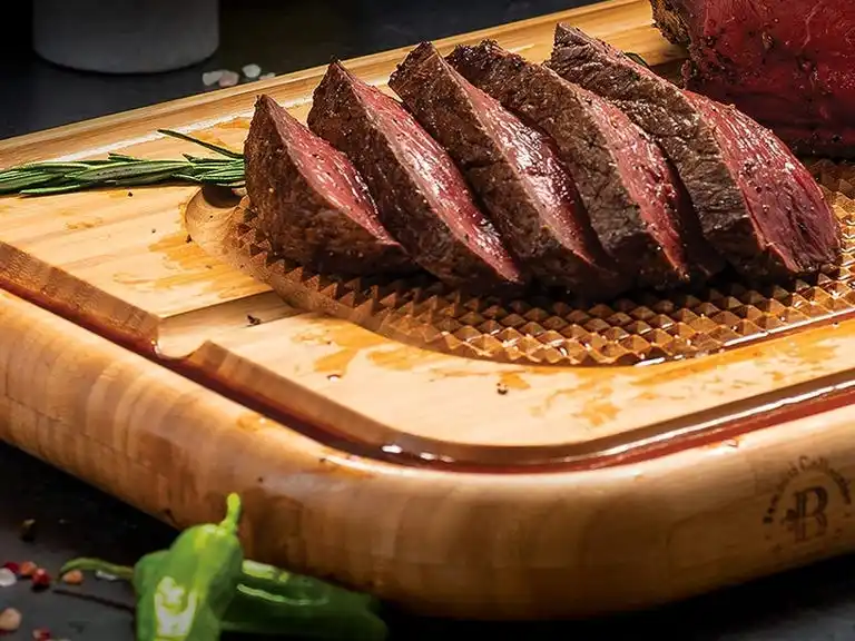 cutting board with meat on top