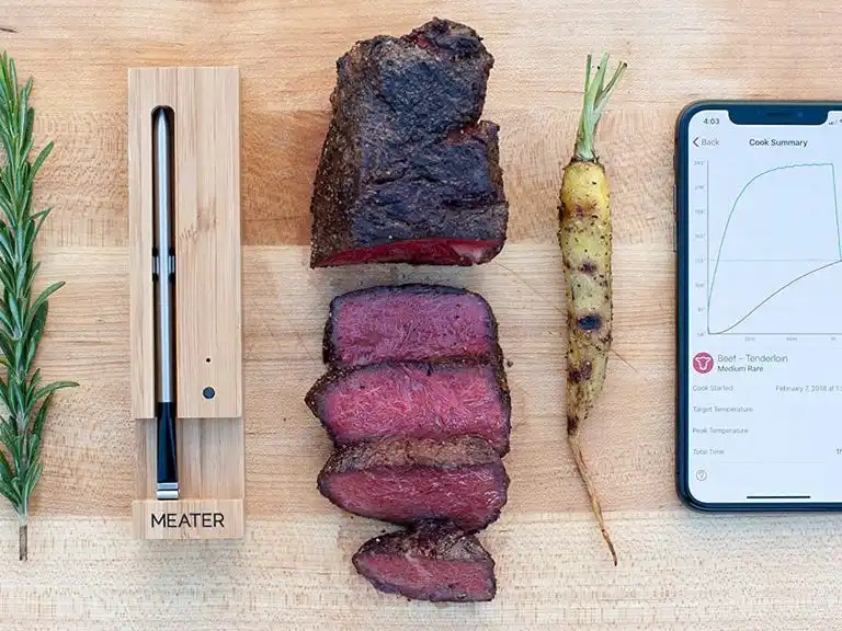 meater probe next to a medium rare steak and an iPhone