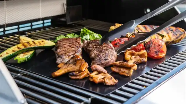 grill mat on grill with meats and veggies