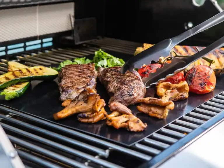 grill mat on grill with meats and veggies