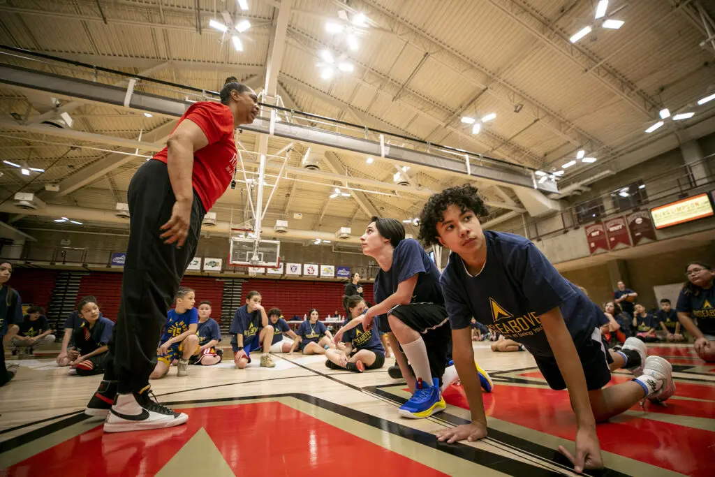 Coach Carla McGheeRise calls for pushups during Above Basketball's clinic at the University of Denver. Jan. 28, 2024.