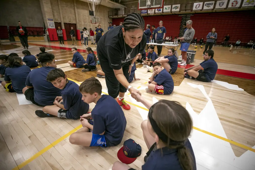 Coach Jaci McCormack shakes hands with each attendee of Rise Above Basketball's clinic at the University of Denver, making them promise to be themselves and avoid dangerous situations. Jan. 28, 2024.