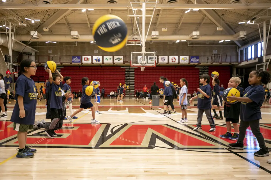 Kids practice passing during Rise Above Basketball's clinic at the University of Denver. Jan. 28, 2024.