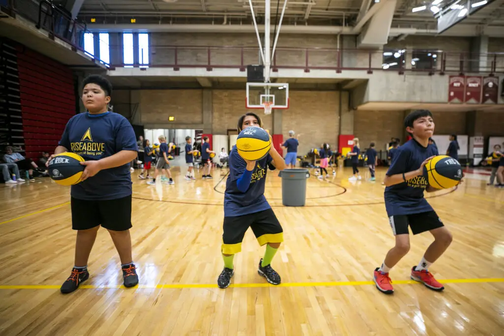 Kadaen (11, left to right), Travis (12) and Gabriel (11) work on their stances during Rise Above Basketball's clinic at the University of Denver. Jan. 28, 2024.