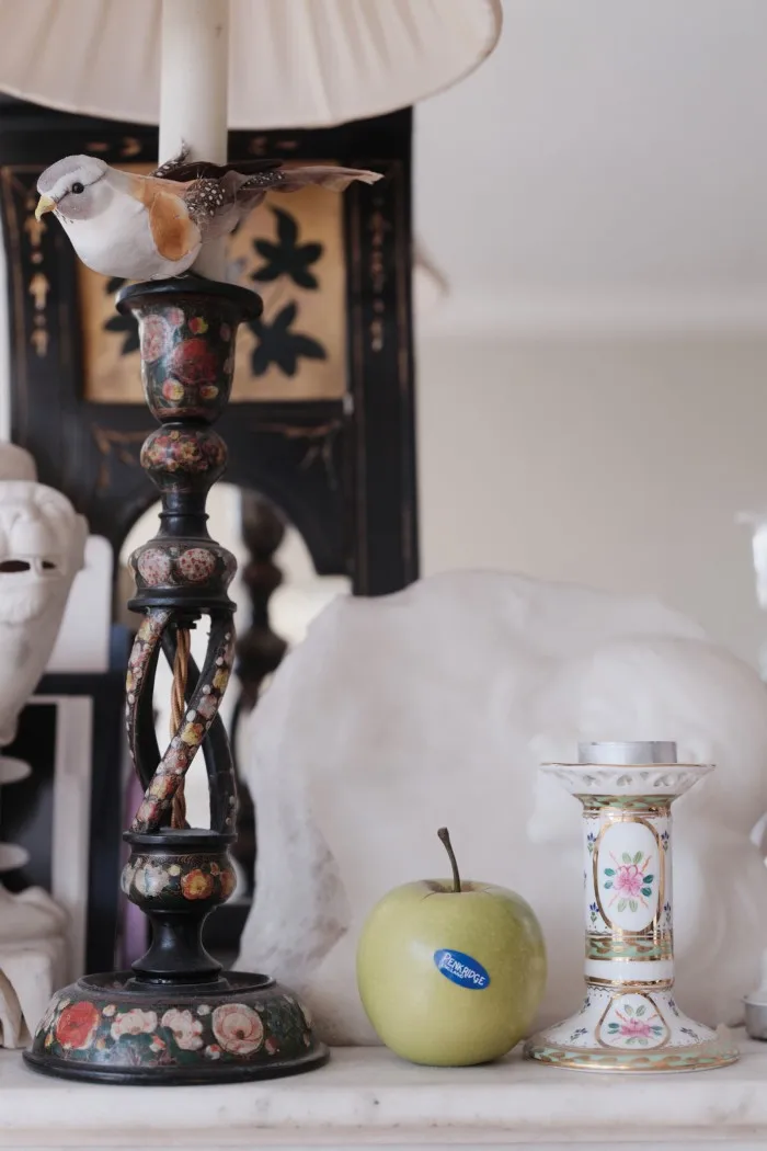The mantelpiece in Blake’s living room with a ceramic apple by Penkridge Ceramics