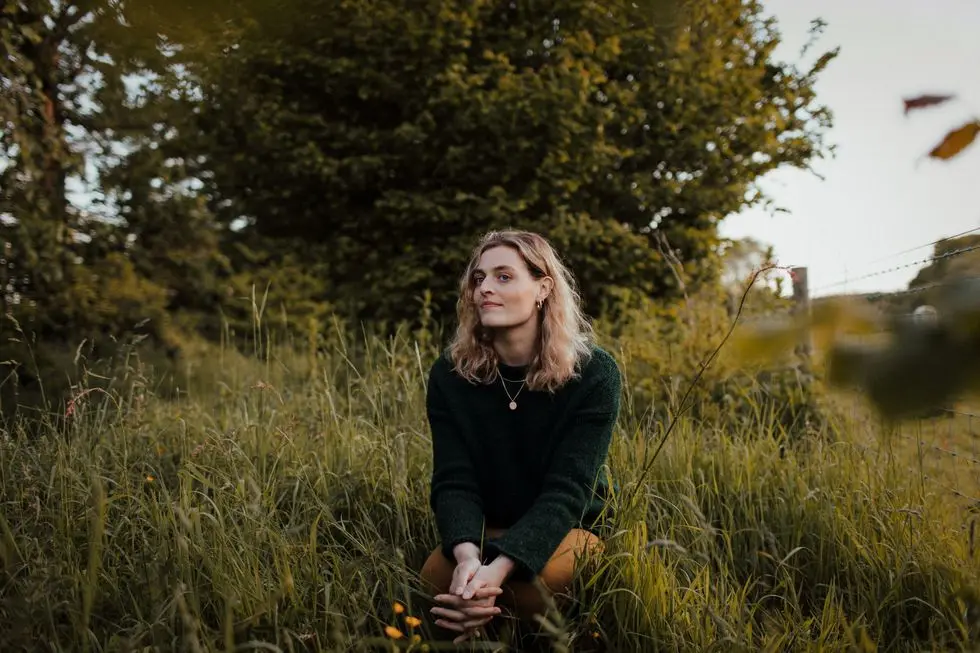 a person sitting in a grassy area