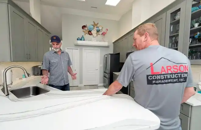 Joe Larson and David Fox of Larson Construction Management shows a recent remodel in Port Orange, Wednesday, Feb. 28, 2024.