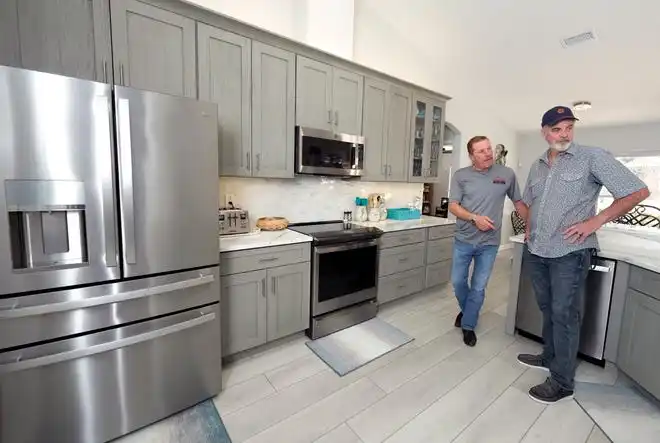 Joe Larson and David Fox of Larson Construction Management shows a recent remodel in Port Orange, Wednesday, Feb. 28, 2024.