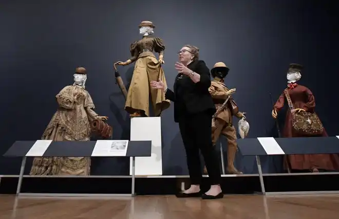 Holly Kerris, the J. Wayne and Delores Barr Weaver Chief Curator at The Cummer Museum of Art & Gardens talks with visitors about the figure on the pedestal's outfit. It was for mountainnerring in the 1890s, and the skirt could be changed into pants by unbuttoning one set of buttons and re-buttoning them to another section of the fabric. The newest exhibit at The Cummer Museum of Art and Gardens, Sporting Fashion: Outdoor Girls 1800 to 1960 opened Wednesday, February 28, 2024. The exhibit is made up of 65 ensembles of women's clothing and other related accessories designed, starting in the early 1900s to simply allow women to get outside to walk and garden and as more opportunities opened up, more activity specific clothing was designed with Western cultural expectations taken into account. The exhibit was organized by the American Federation of the Arts and FIDM Museum of the Fashion Institute of Design & Merchandising in Los Angeles.