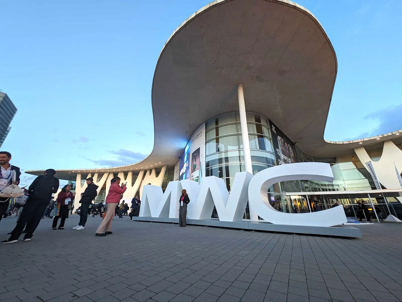 MWC signage and people near a building