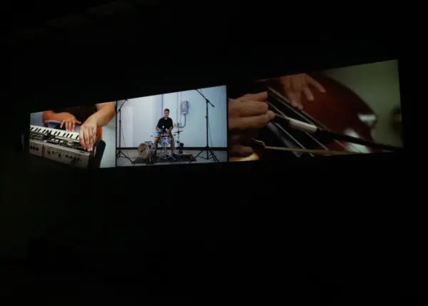A photograph of a three-channel video projection.