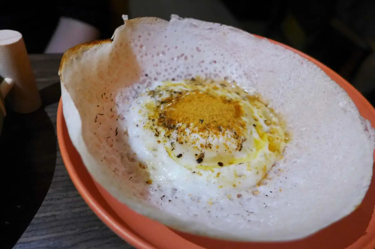 A white bowl of a bread.