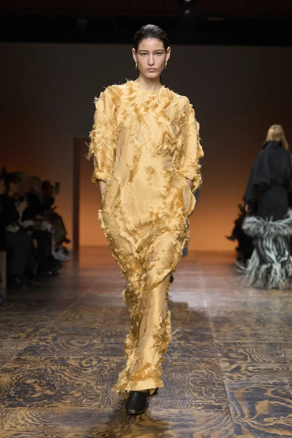 a person wearing a gold dress