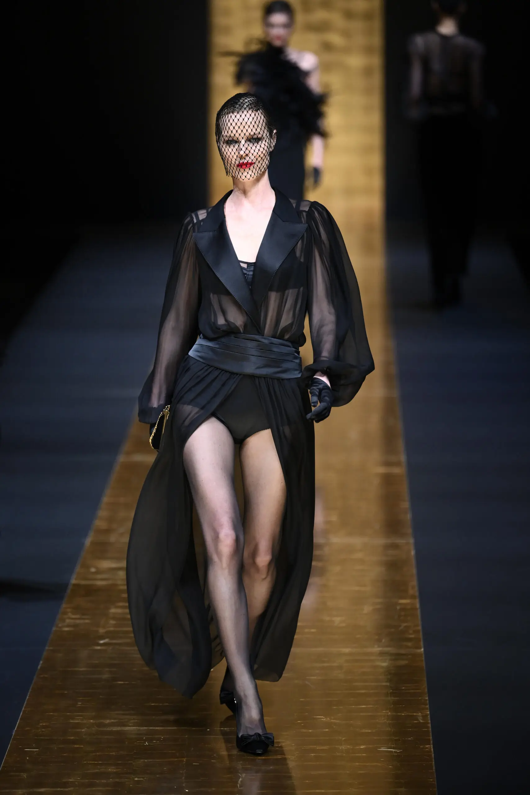 Transparent silk skirts and blouses featured prominently in the all-black collection from Dolce & Gabanna.