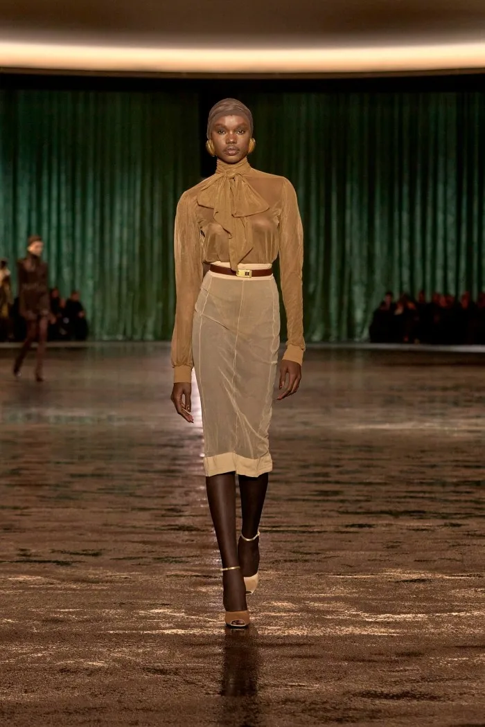 A model wears a diaphonous skirt and pussy-bow blouse