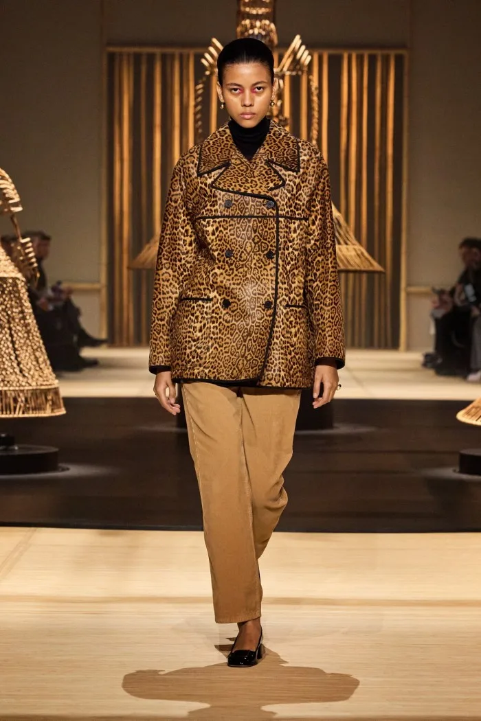 A model wears a leopard-print peacoat and beige trousers