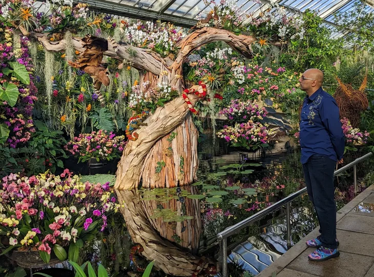 Tabish Khan standing next to a floral display