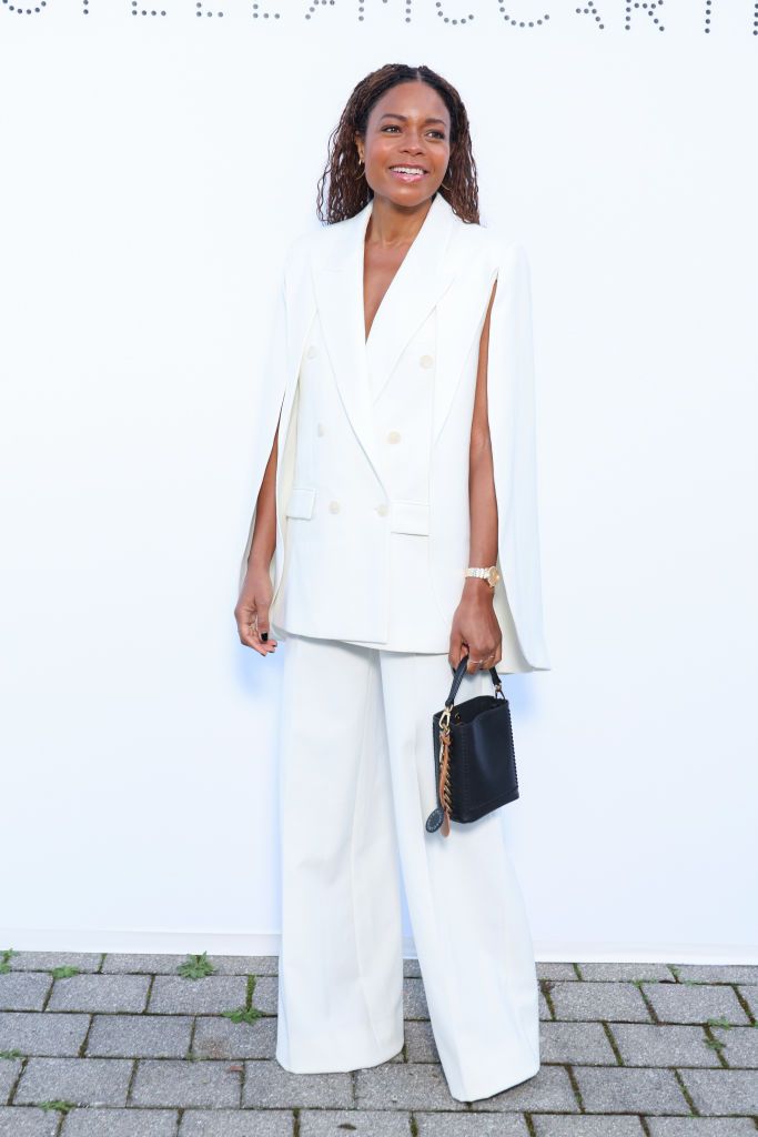 Naomi Harris is elegant in caped tailoring for Paris Fashion Week