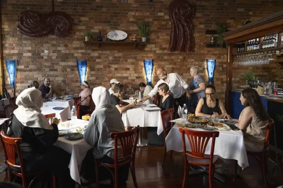 Aydin Bol (pictured in white, delivering a dish to a table) is a constant presence at his 30-year-old Turkish restaurant.