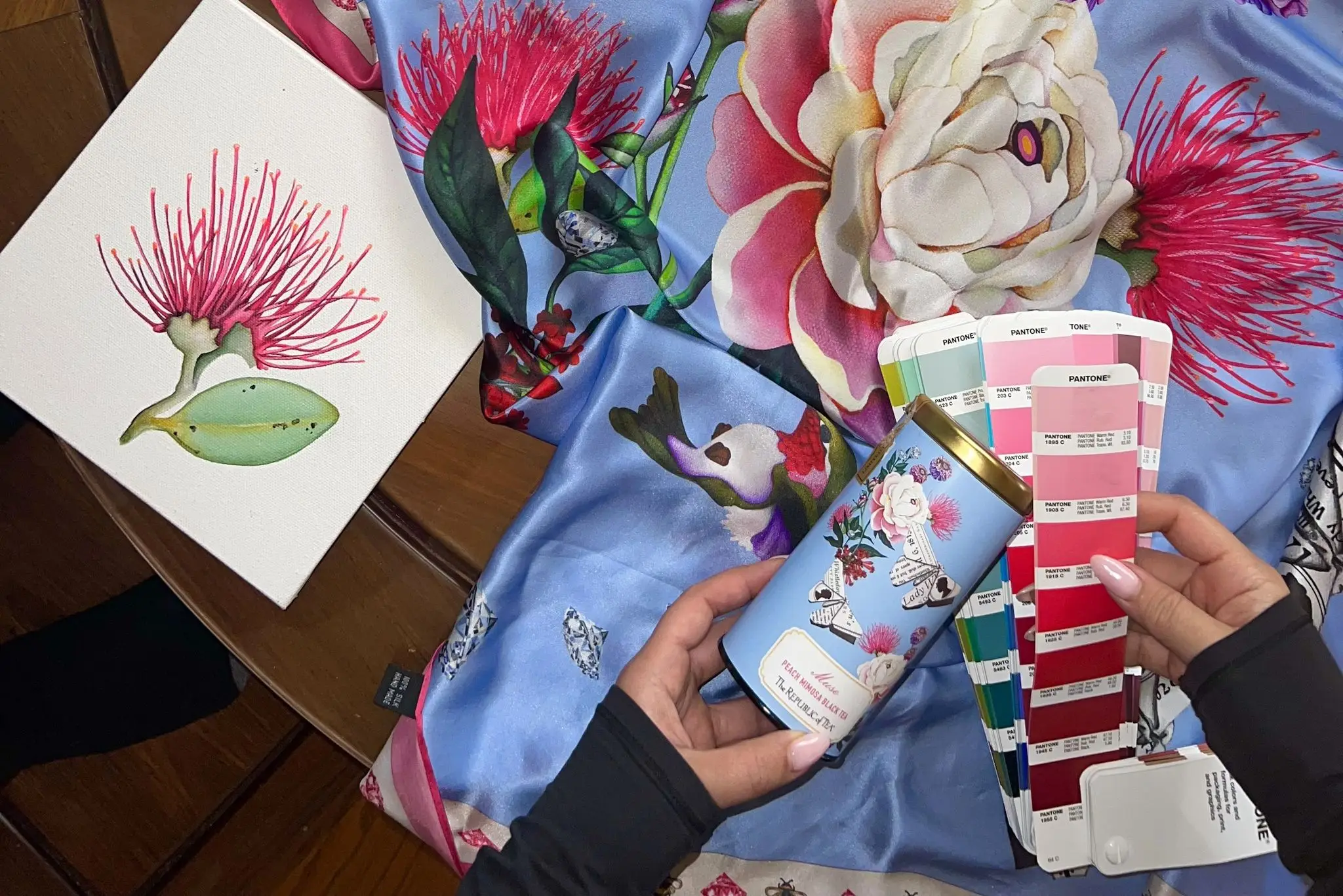 sue tsai's paiting, a painted scarf, and a tea canister
