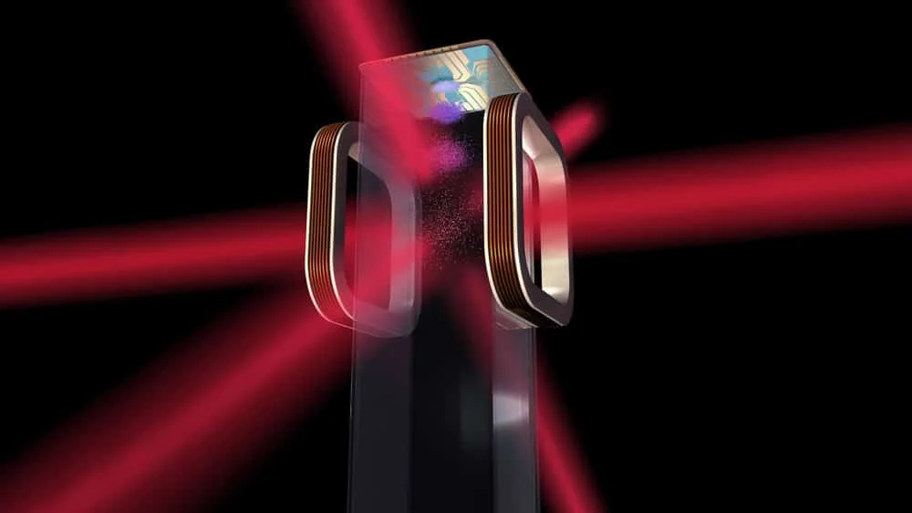 Image showing six red laser beams crossing inside a chamber with a chip suspended above it