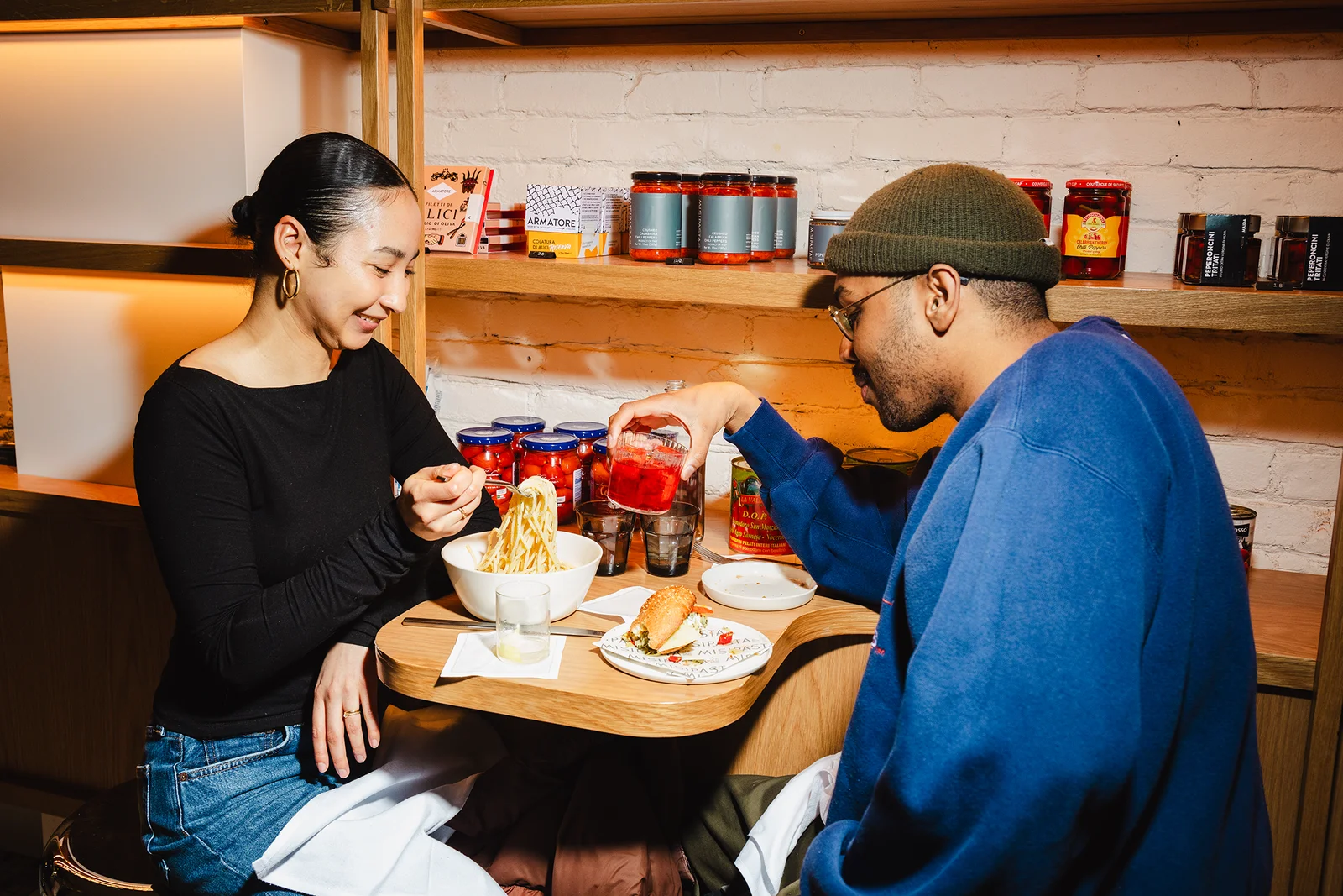 Two people eating at a table.