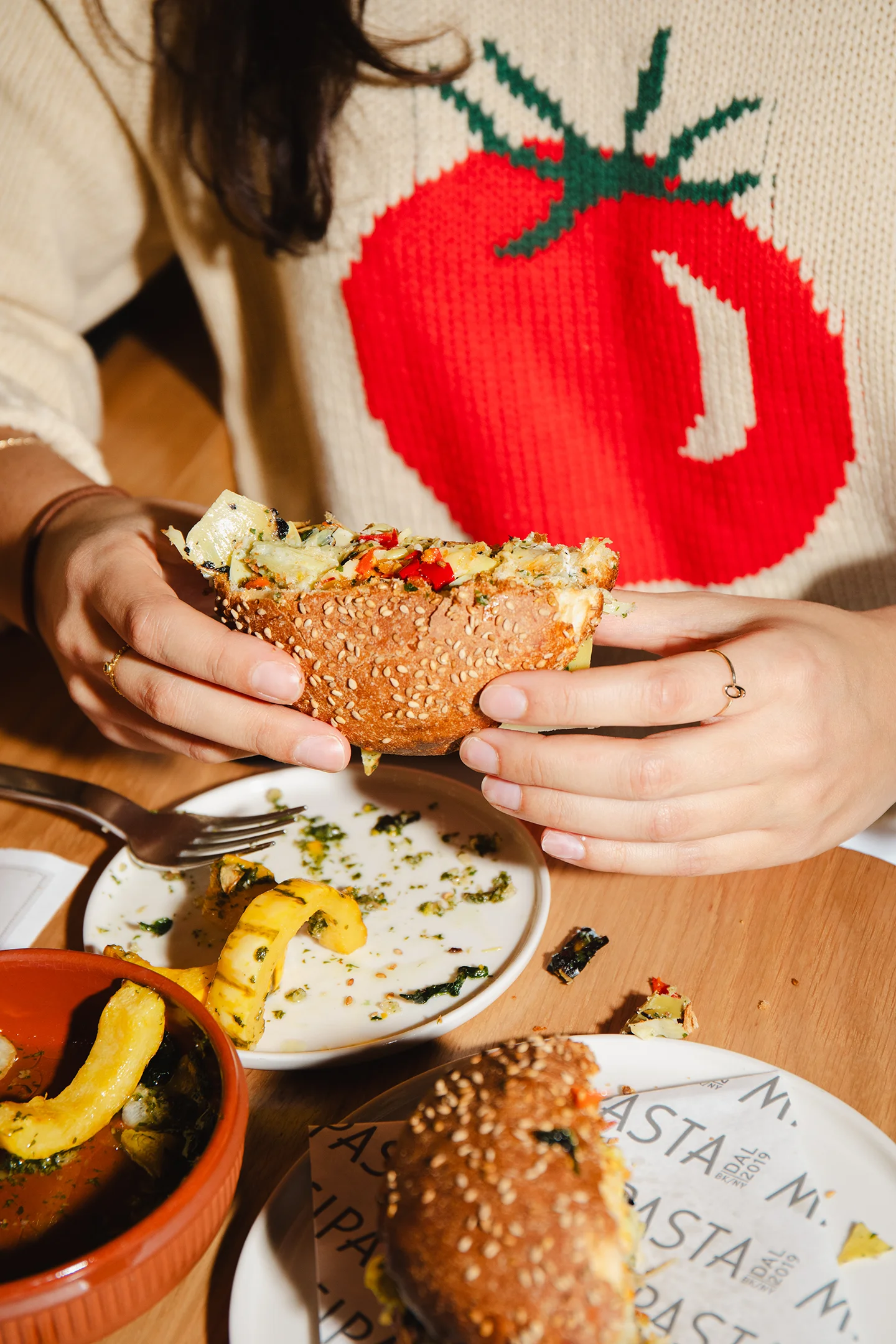 A person holding half a sandwich.