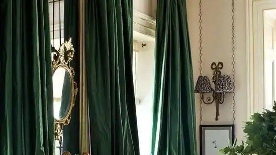 Fabric Drapes and Throws: Use rich fabrics like velvet or silk in deep jewel tones to drape over furniture or hang as curtains, creating a cozy and luxurious ambiance. (Pinterest)