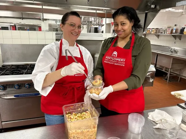 Food Sustainability Fellow in the Hospitality Institute Jennifer Fanega and Karima Roepel, Director of the Hospitality Institute, work together to create meals for the Stock Up for Success Food Pantry, as part of the new Food Recovery Program. (Photo by Eric Devlin)