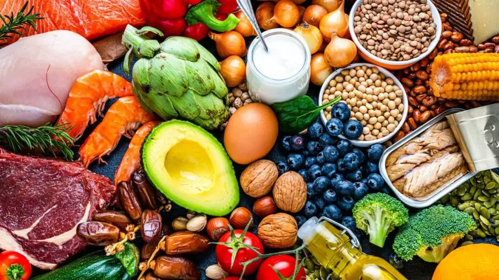 Atlantic Diet: Overhead view of a large group of healthy raw food for flexitarian mediterranean diet. The composition includes salmon, chicken breast, canned tuna, cow steak, fruits, vegetables, nuts, seeds, dairi products, olive oil, eggs and legumes. High resolution 42Mp studio digital capture taken with SONY A7rII and Zeiss Batis 40mm F2.0 CF lens