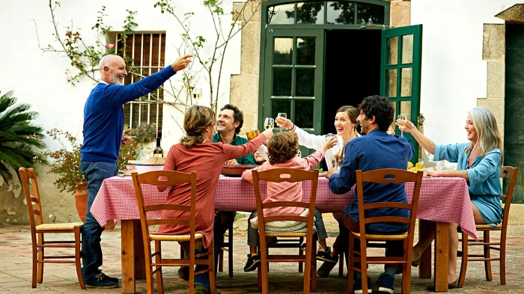 extended family enjoying dinner together outdoors; atlantic diet 