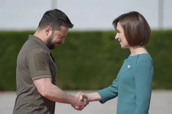 FILE - Moldova's President Maia Sandu, right, greets Ukraine's President Volodymyr Zelenskyy in Bulboaca, Moldova, June 1, 2023. She has been a frequent target of online disinformation created with artificial intelligence. (AP Photo/Vadim Ghirda, File)