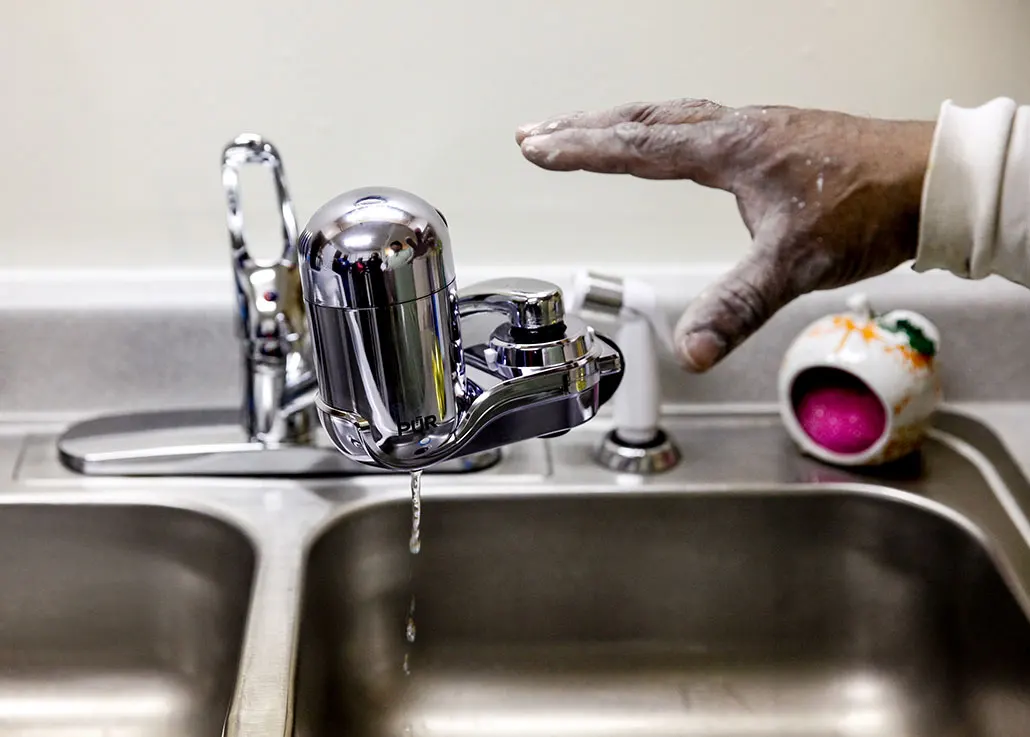 a photo of a lead water filter installed on a kitchen sink faucet