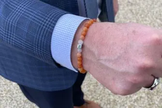 Chris Young, a principal from VT, wears ‘Nora beads’ as a reminder of a student at his school who died by suicide.