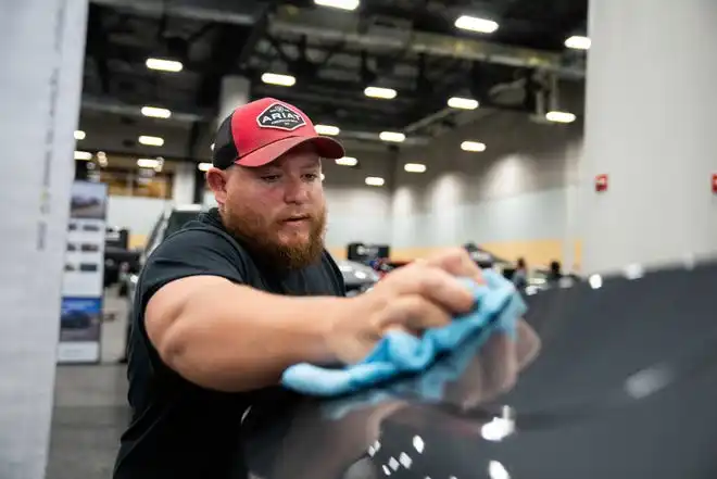 William Smith polishes a Ford F-150 as he prepares for the All Iowa Auto Show Thursday, March 14, 2024, at the Iowa Events Center.