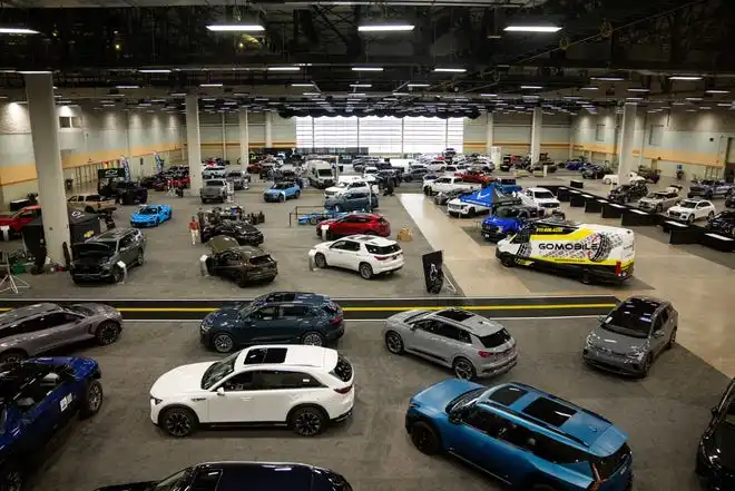 Cars sit on the event center floor as dealers set up for the All Iowa Auto Show Thursday, March 14, 2024, at the Iowa Events Center.