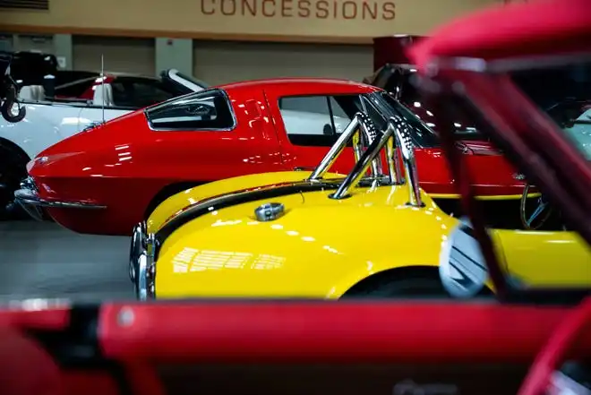 Classic Cars sit at the back of the event center at a booth by Perk's Auto Spa Thursday, March 14, 2024, at the Iowa Events Center.