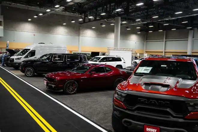 Vehicles from more than a dozen manufacturers sit on the event center floor during set up for the All Iowa Auto Show Thursday, March 14, 2024, at the Iowa Events Center.