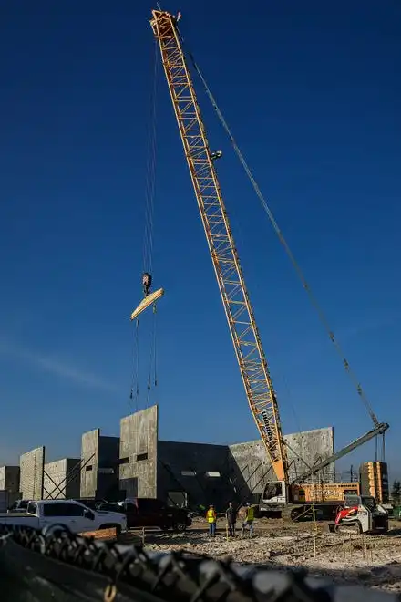 A crane places a section as tilt-wall construction continues on The Education Foundation of Palm Beach County's new Innovation Hub near Barton Elementary School on March 8, 2024, on the south-side of Lake Worth Beach, Fla. The new facility is planned to be open by December this year.