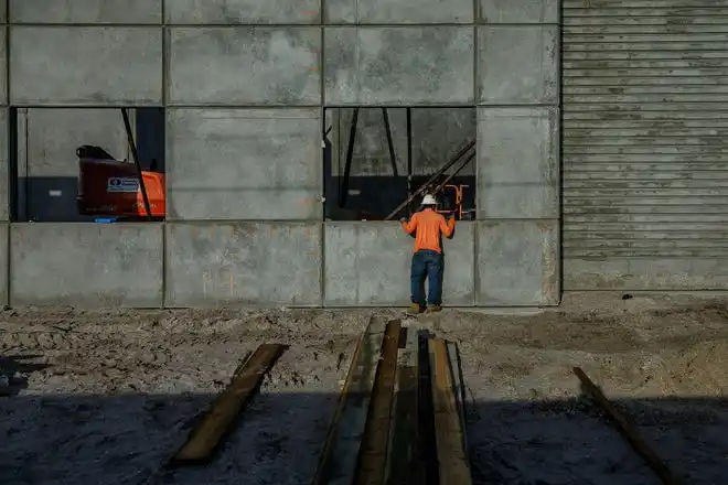 Workers tend to morning tasks on the construction site at The Education Foundation of Palm Beach County's new Innovation Hub near Barton Elementary School on March 8, 2024, on the south-side of Lake Worth Beach, Fla. The new facility is planned to be open by December this year.