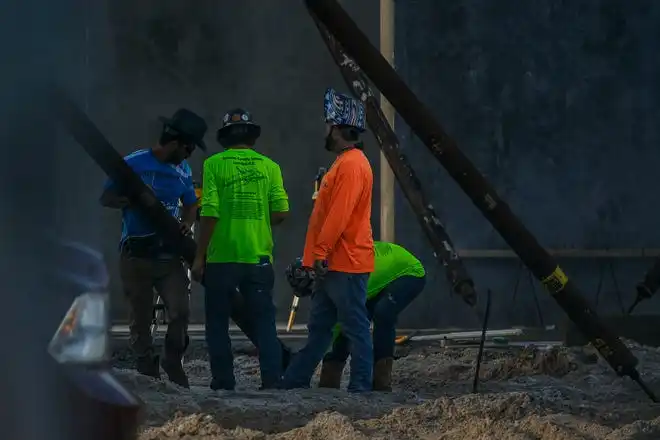 Men place a brace during tilt-wall construction at The Education Foundation of Palm Beach County's new Innovation Hub near Barton Elementary School on March 8, 2024, on the south-side of Lake Worth Beach, Fla. The new facility is planned to be open by December this year.