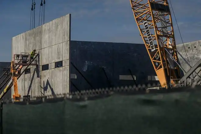 A laborer places a brace bolt during morning tilt-wall construction at The Education Foundation of Palm Beach County's new Innovation Hub near Barton Elementary School on March 8, 2024, on the south-side of Lake Worth Beach, Fla. The new facility is planned to be open by December this year.